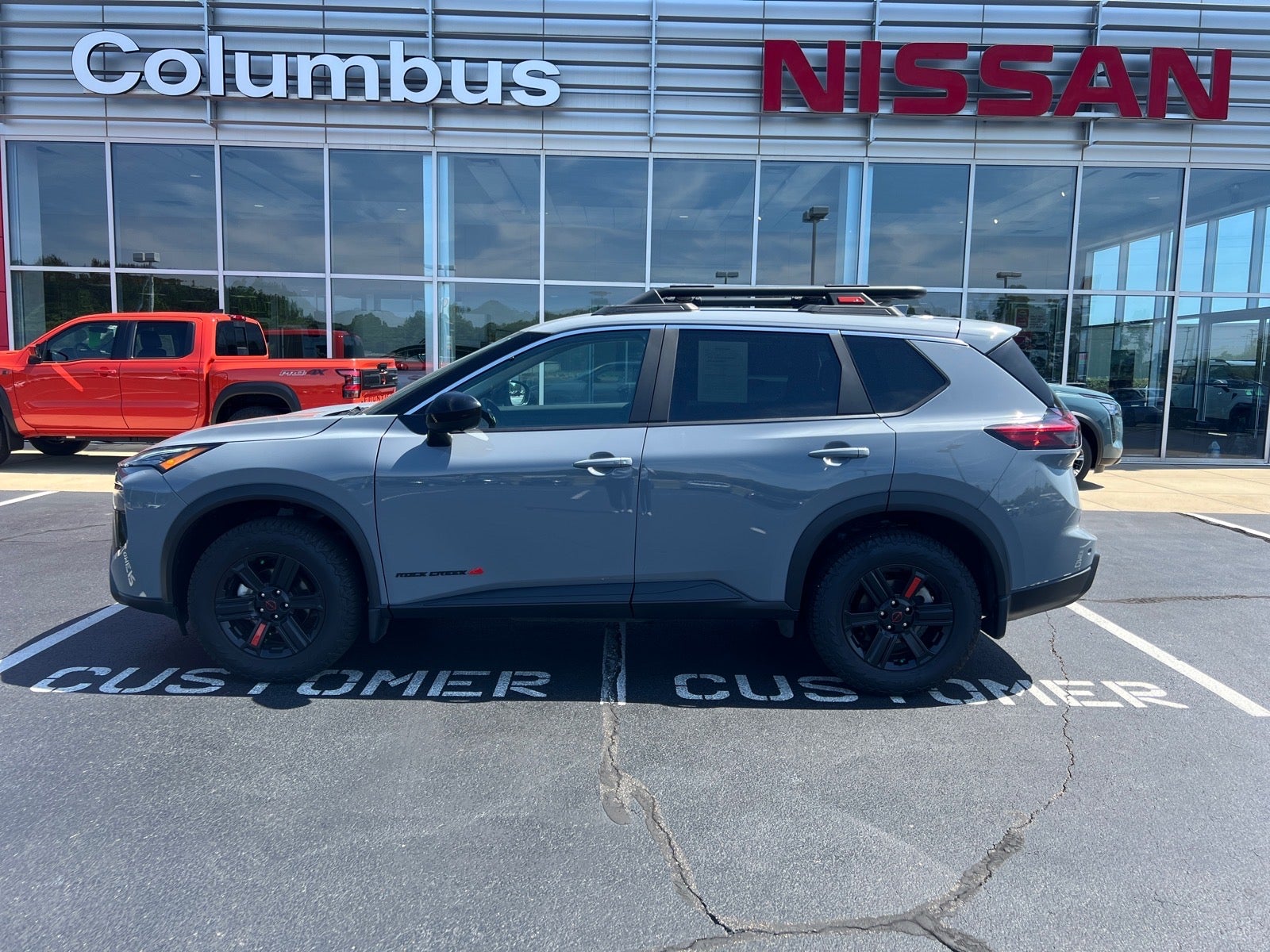 2025 Nissan Rogue Rock Creek in Gray — front three-quarter view