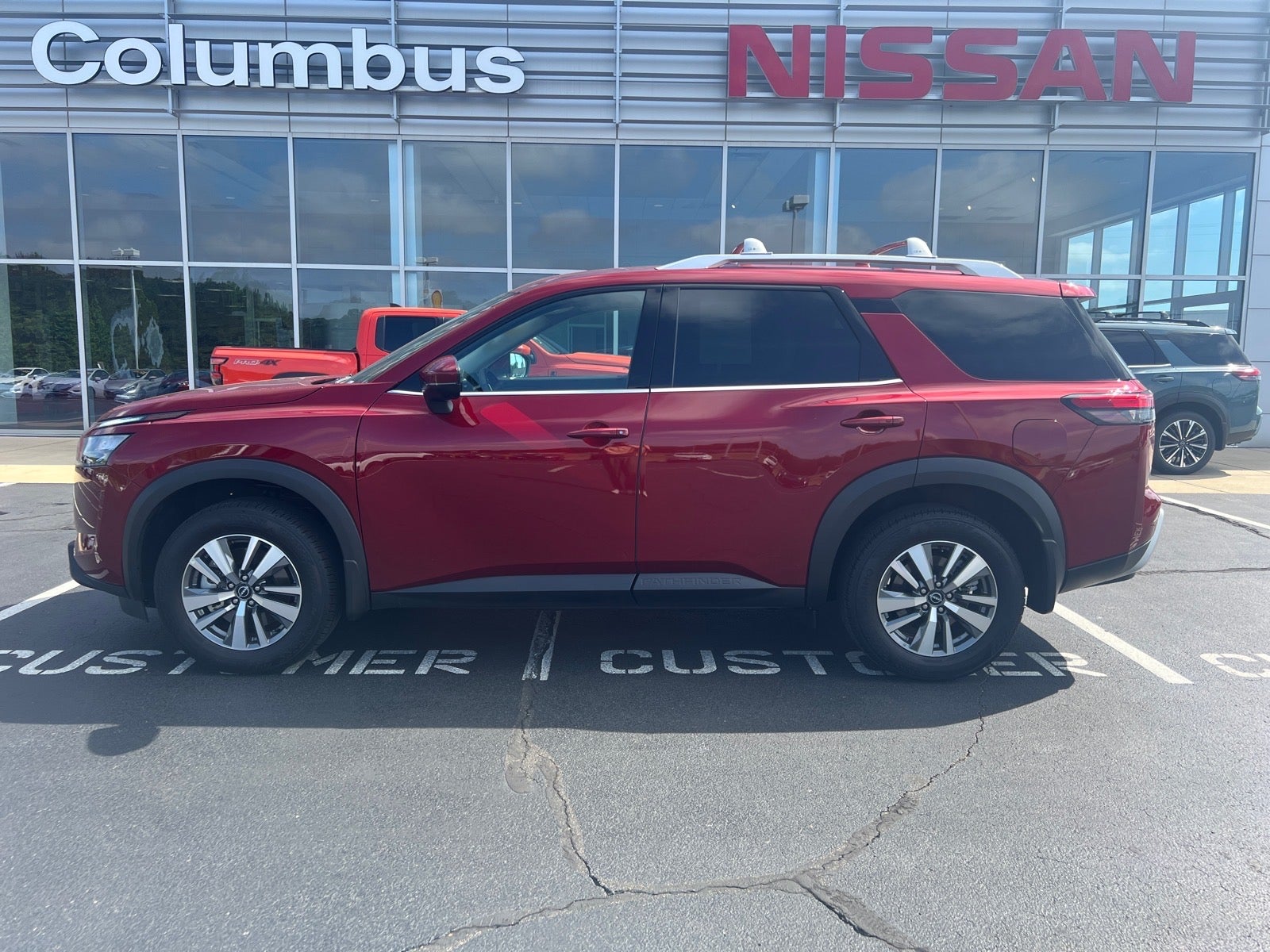 2025 Nissan Pathfinder SL in Red — front three-quarter view